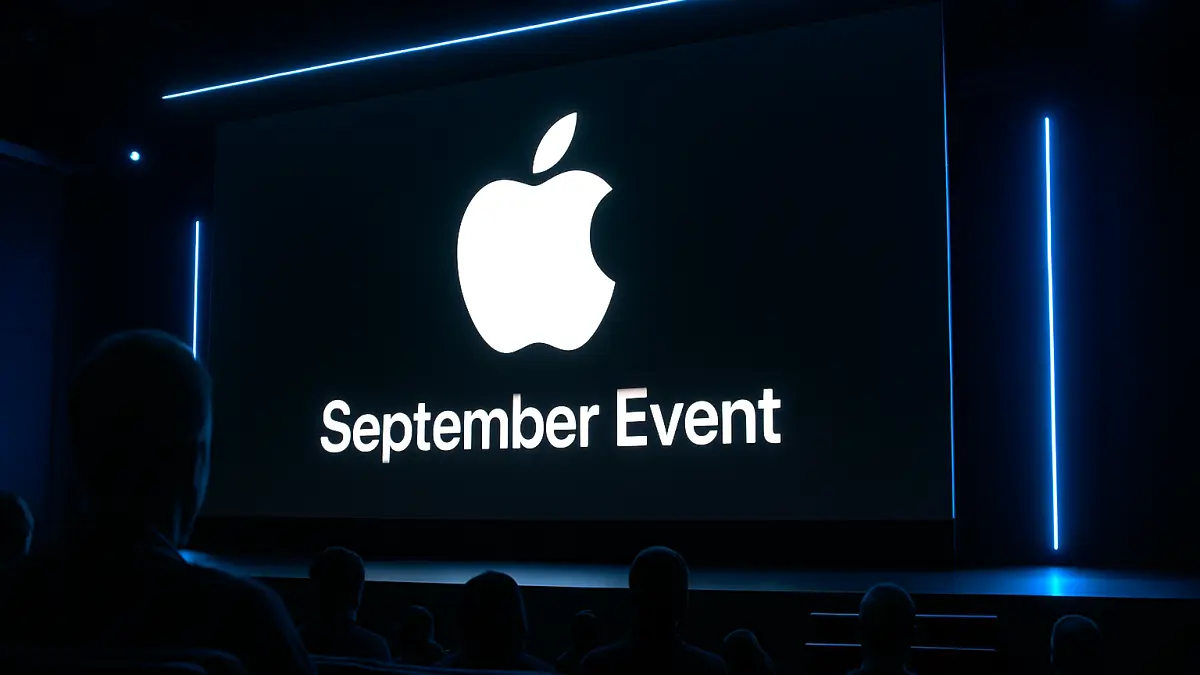 Dark auditorium with audience facing a large screen displaying a white Apple logo and the words "September Event" in bright text
