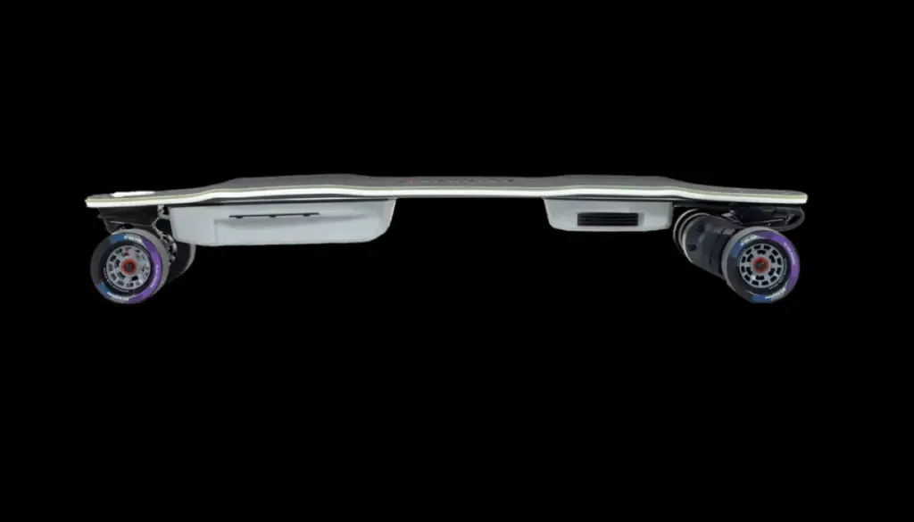 Low-profile electric skateboard viewed from the side, showing sleek deck, motorized wheels, and battery compartments against a black background