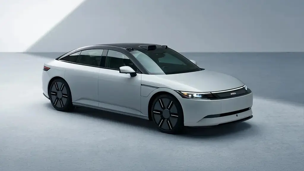 Minimalist futuristic electric sedan concept car displayed in a clean studio environment at CES 2026 showcasing next-generation mobility design